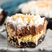 sliced pie with whipped cream and coconut on top.