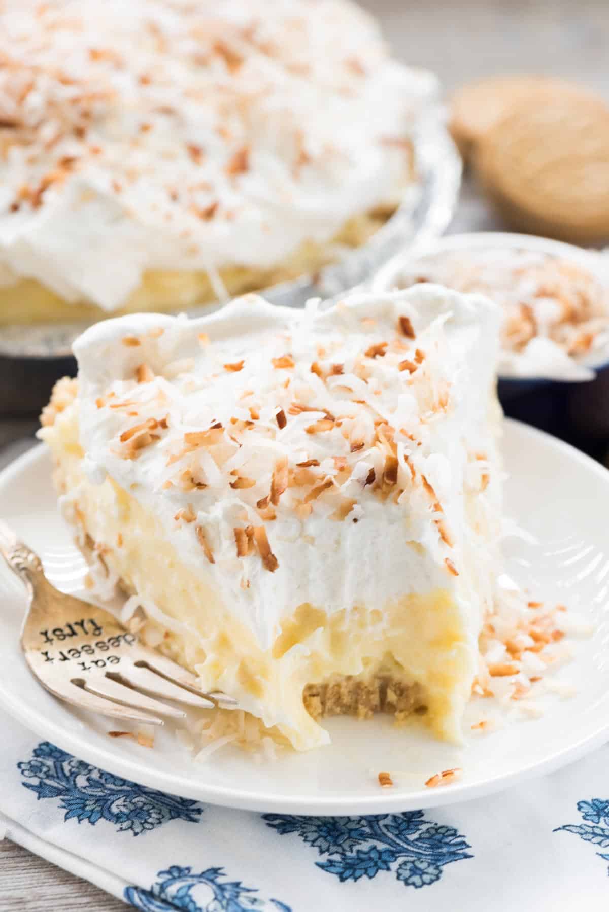 slice of pie on white plate with fork and missing bite.